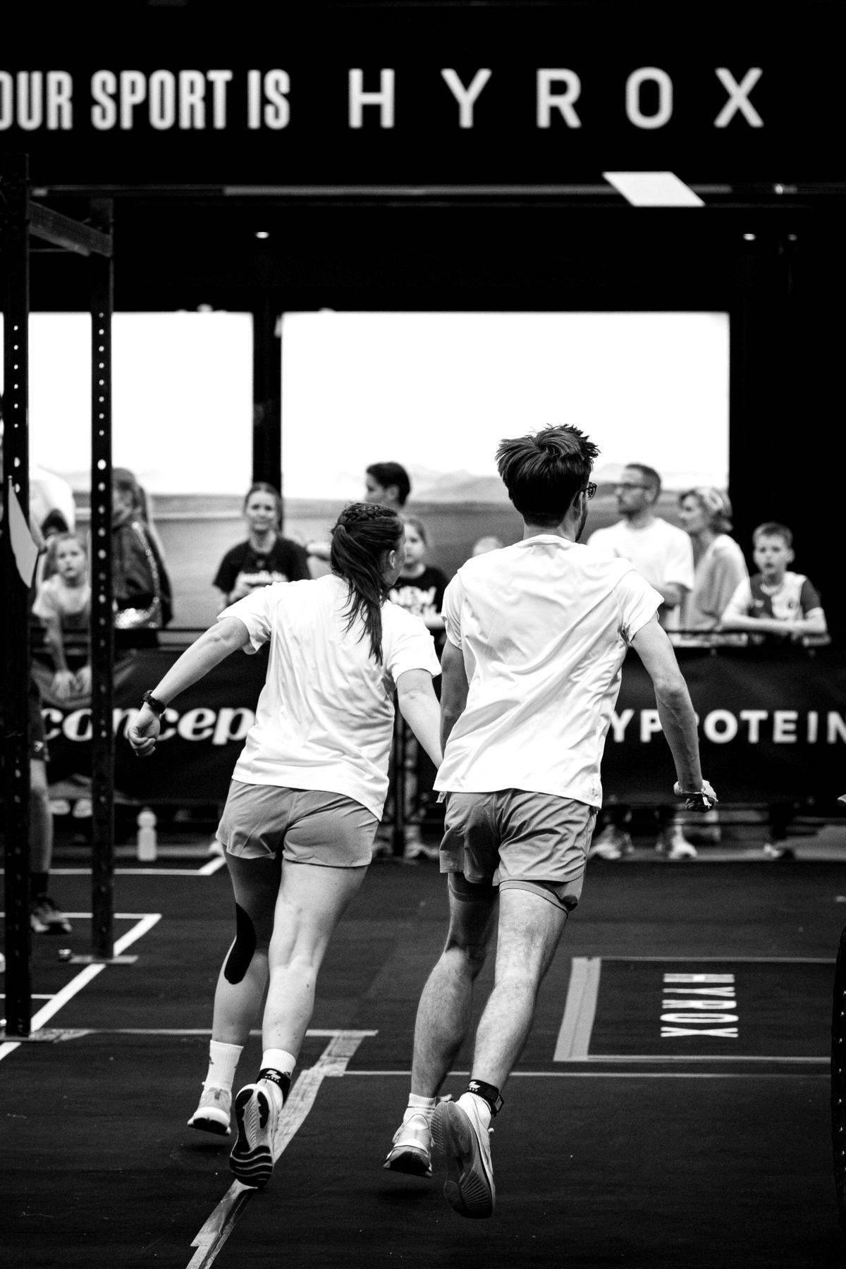 A doubles pair running toward the crowd at the finish