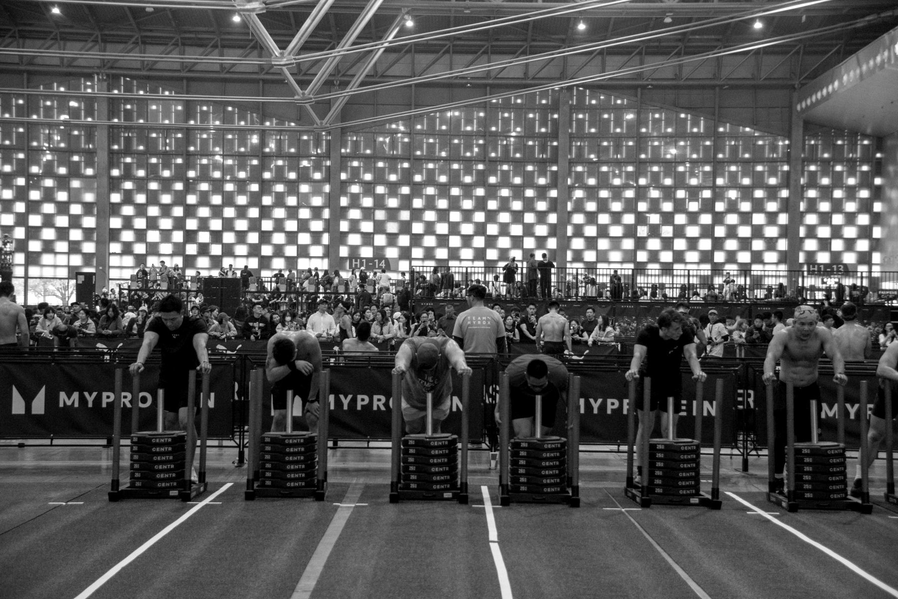 Athletes on the start line in a packed HYROX arena